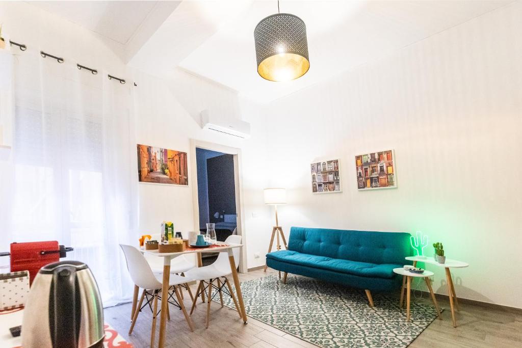 uma sala de estar com um sofá azul e uma mesa em Brutia Mom&Son em Cosenza