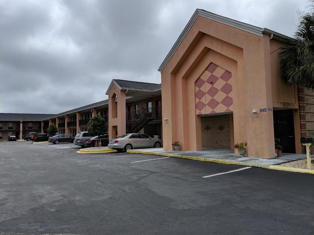 a parking lot in front of a hotel with cars parked at Economy Inn Express in Rock Hill