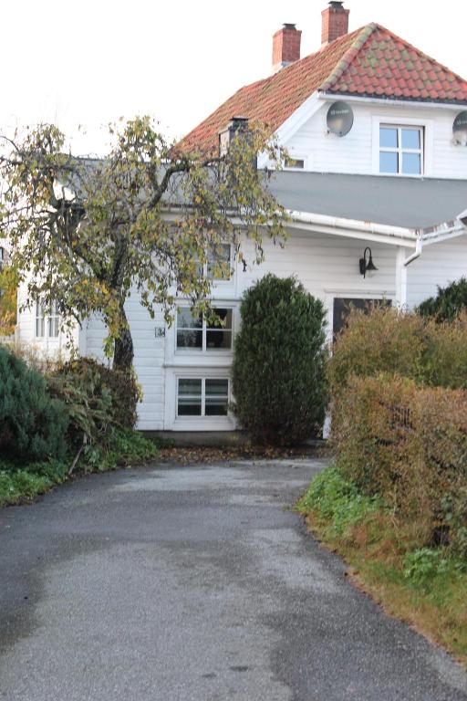a white house with a driveway in front of it at Bullseye Kristiansand in Kristiansand