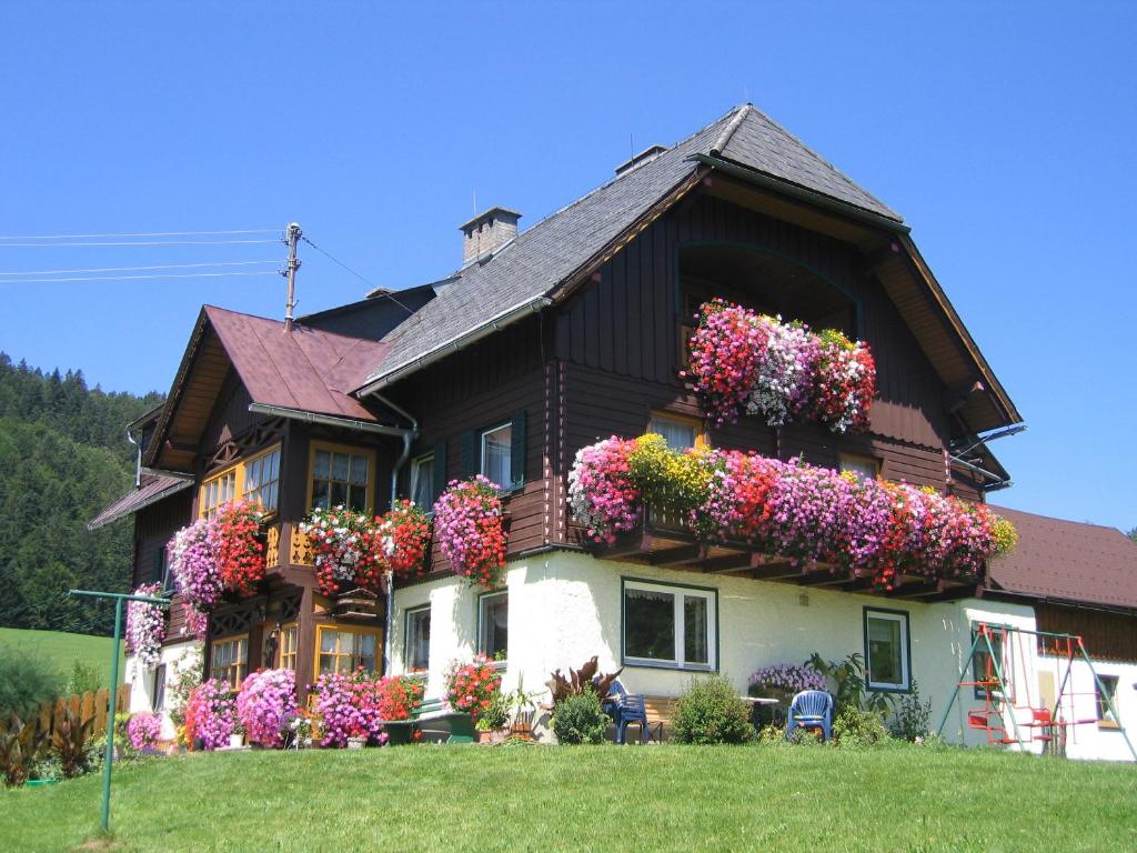 a house with lots of flowers on it at Bauernhof Haim in Pichl bei Aussee