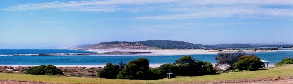 a view of a beach with a house and the ocean at Kalbarri Riverfront Unit in Kalbarri