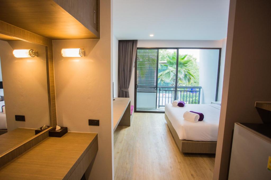 Postel nebo postele na pokoji v ubytování Chaweng Villawee Hotel