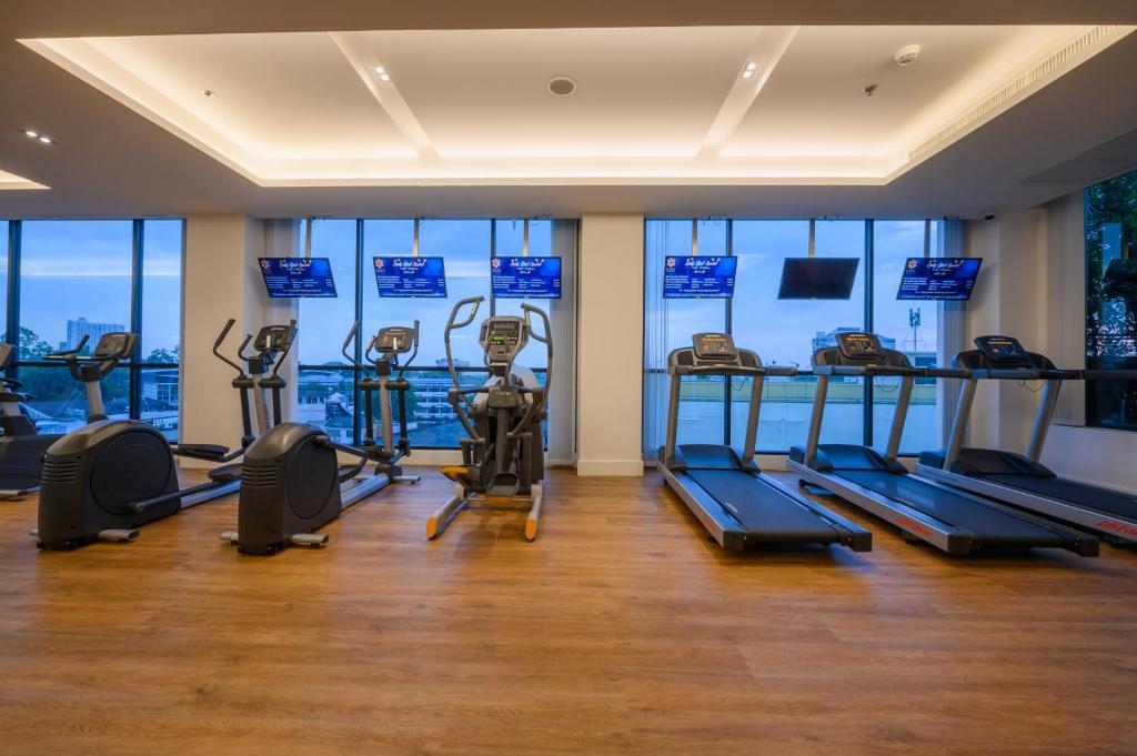 A cardio room lines its windows with treadmills and elliptical machines.