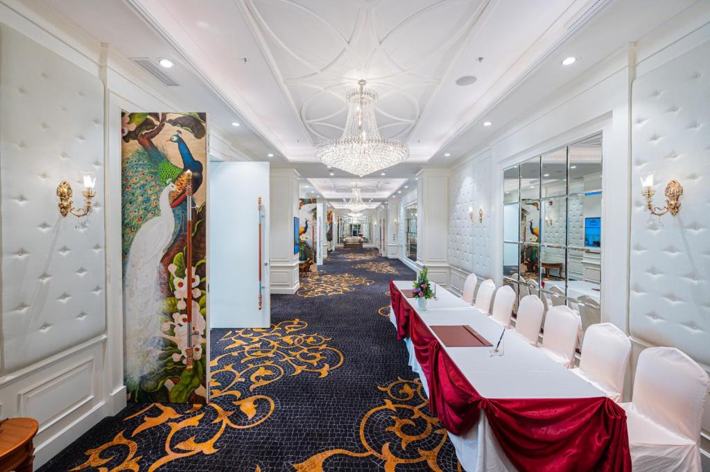 A formal meeting-room setup in a bright, ornate hotel corridor.