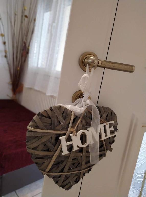 a heart on a door with a hoice sign on it at Nice and cosy house 2 in Larisa