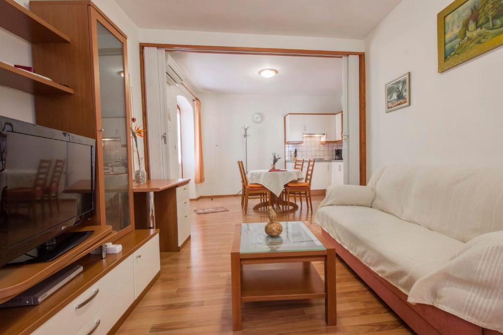 a living room with a couch and a table at Apartments Konta Vodice in Vodice