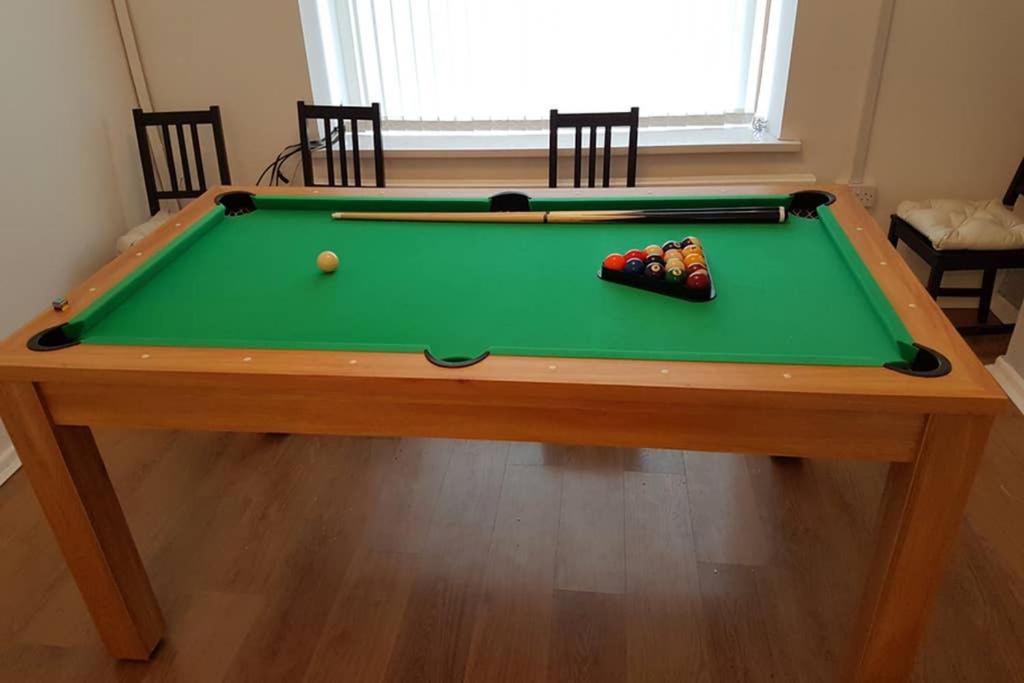 a green pool table with two balls on it at Afan Valley Holiday Home Mountain Biking & Hiking - Yr Hafan in Port Talbot