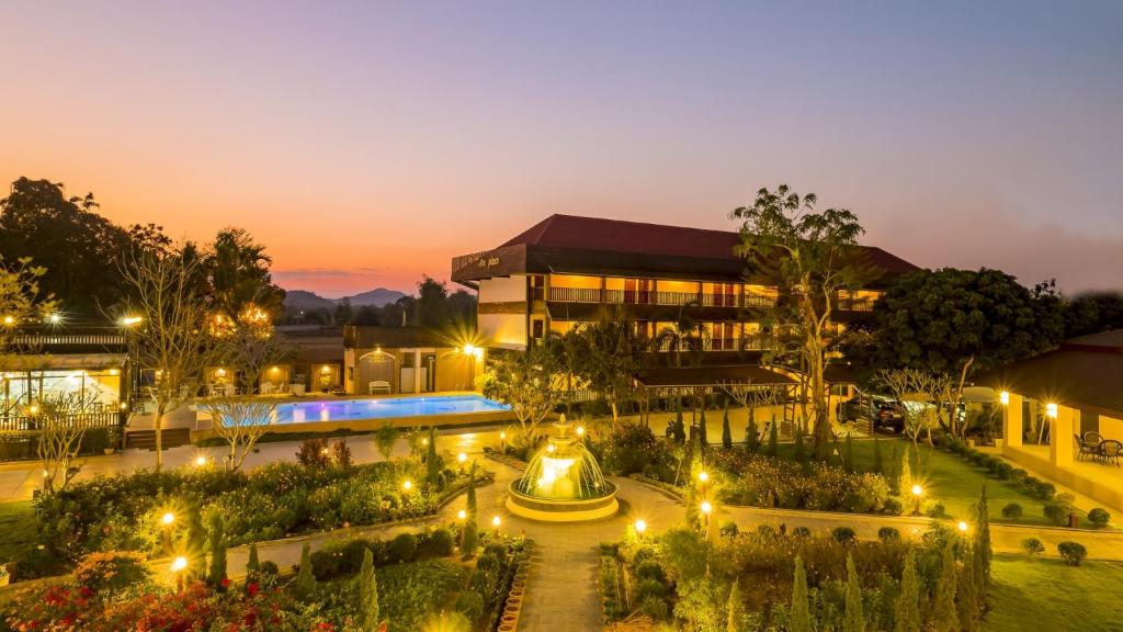 a building with a garden at night at AU Place Hotel in Loei