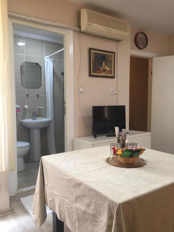 a bathroom with a table with a bowl of fruit on it at Paxx Istanbul Hotel & Hostel in Istanbul