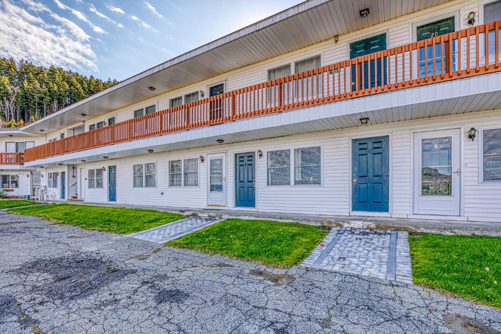 a building with blue doors and a balcony at Moosehead Condo Unit #5 in Rockwood