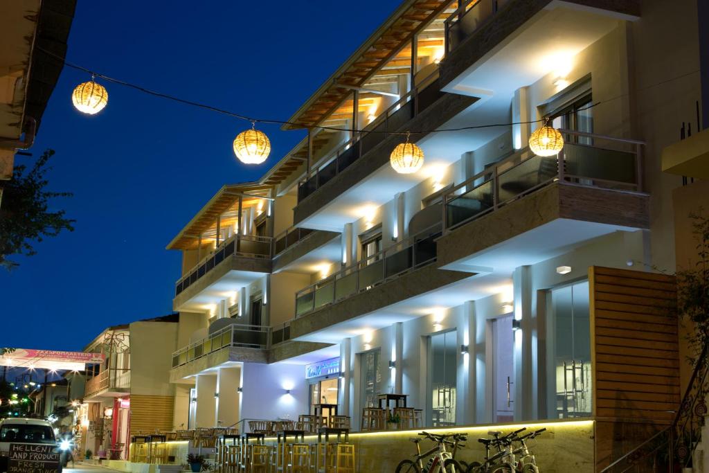 a building with lights on it at night at Grand TheoNi Boutique Hotel & Spa in Vasiliki