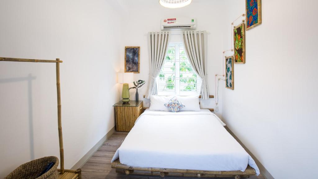 Postel nebo postele na pokoji v ubytování Nem's House Hội An
