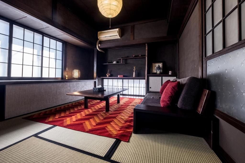 a living room with a couch and a table at Classic Japan Living Kawamuraya in Fujikawaguchiko
