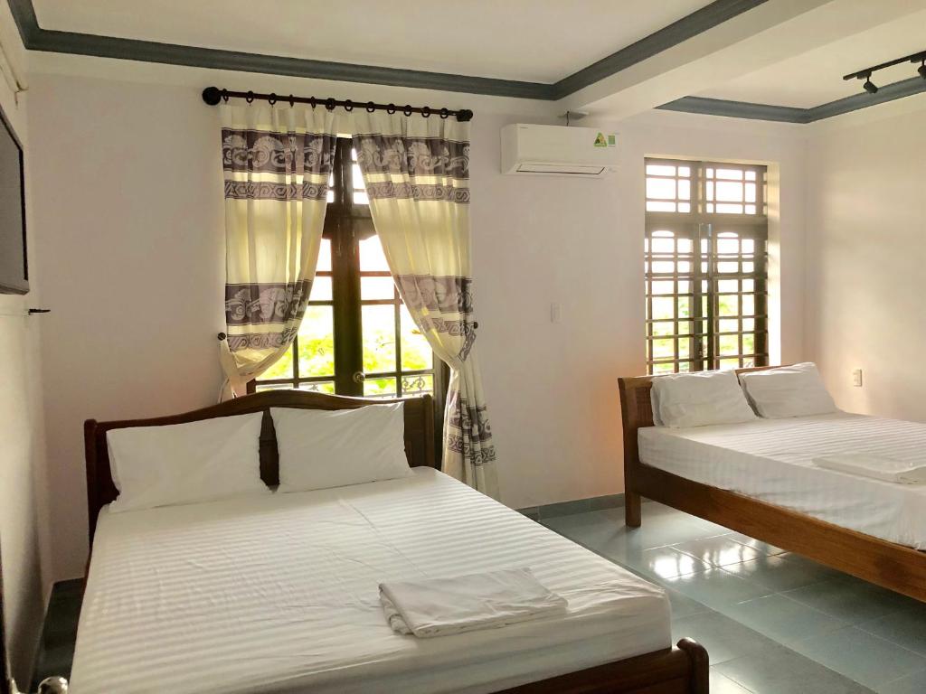 Postel nebo postele na pokoji v ubytování Hai Dang Homestay