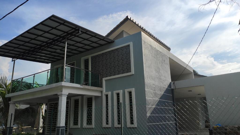 uma casa com uma cerca em frente em FRA Homestay em Kuantan