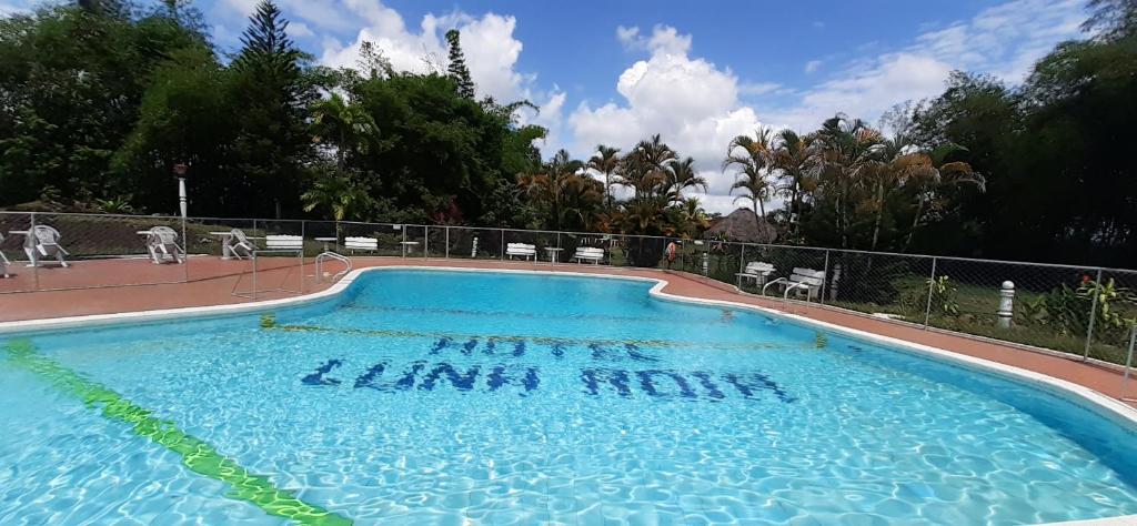 a swimming pool with writing on the side of it at Hotel Campestre Luna Roja in Puerto López