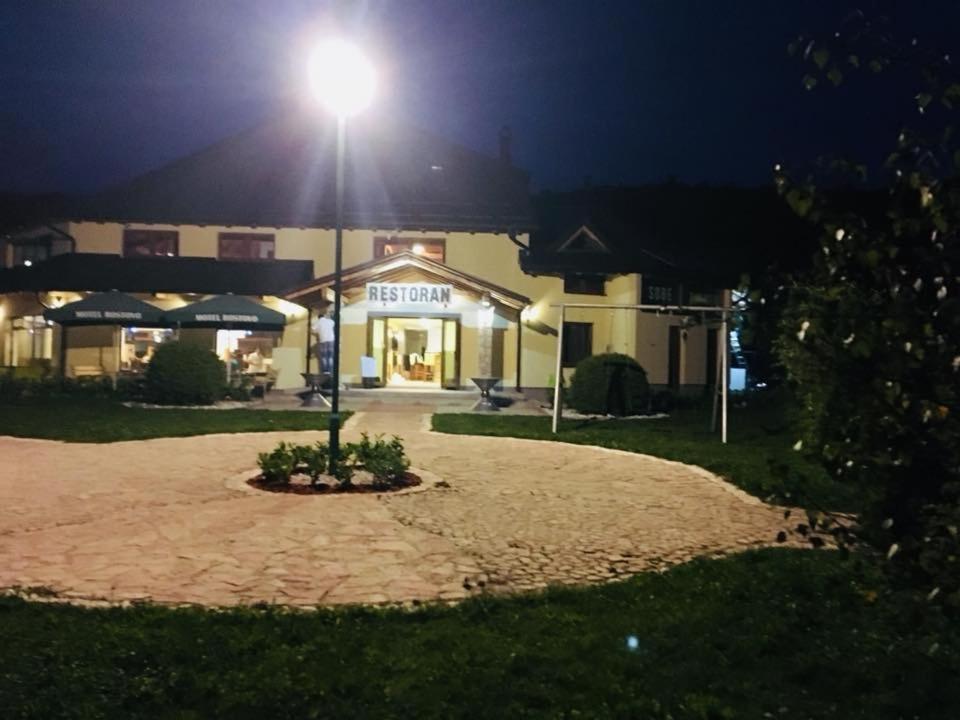 a building with a light on top of it at night at OMLADINSKI HOTEL ROSTOVO in Bugojno