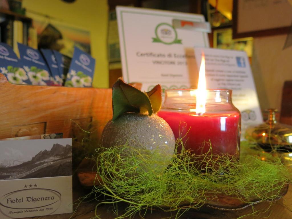 a candle sitting next to a display of a fruit at Digonera Historic Hotel B&B in Rocca Pietore