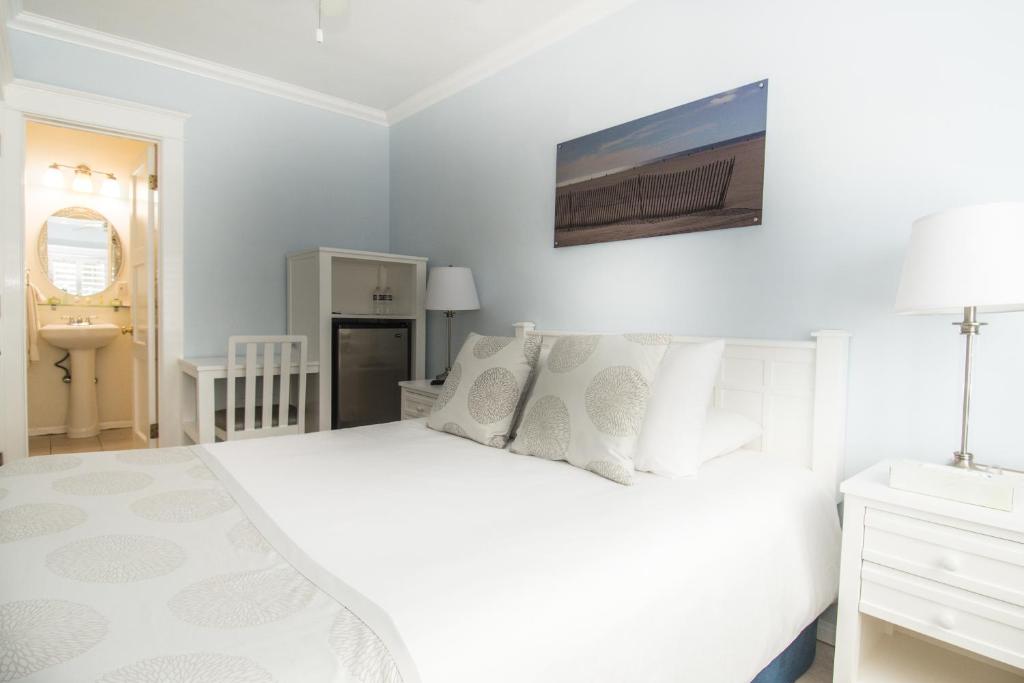 a white bedroom with a white bed and a sink at Venice on the Beach Hotel in Los Angeles