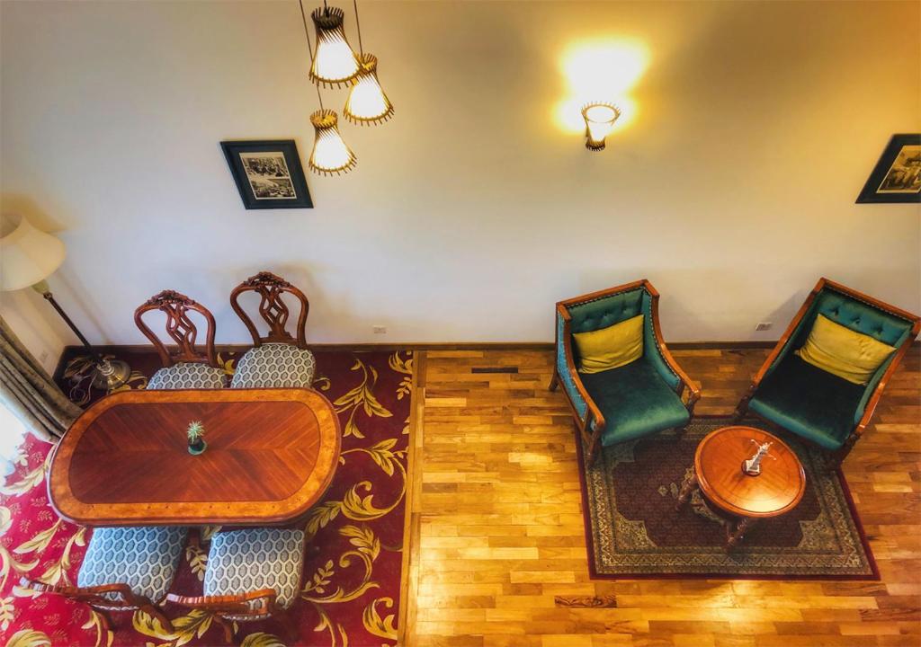 a living room with chairs and a table and a couch at The Blackpool Resort & Spa in Nuwara Eliya