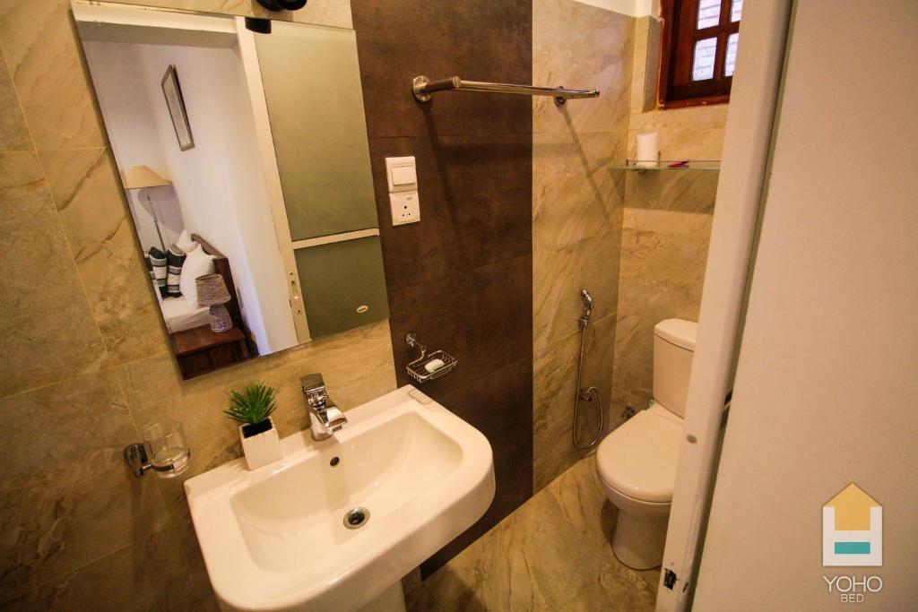 a bathroom with a sink and a toilet and a shower at Airport Green Olive Villa in Katunayaka