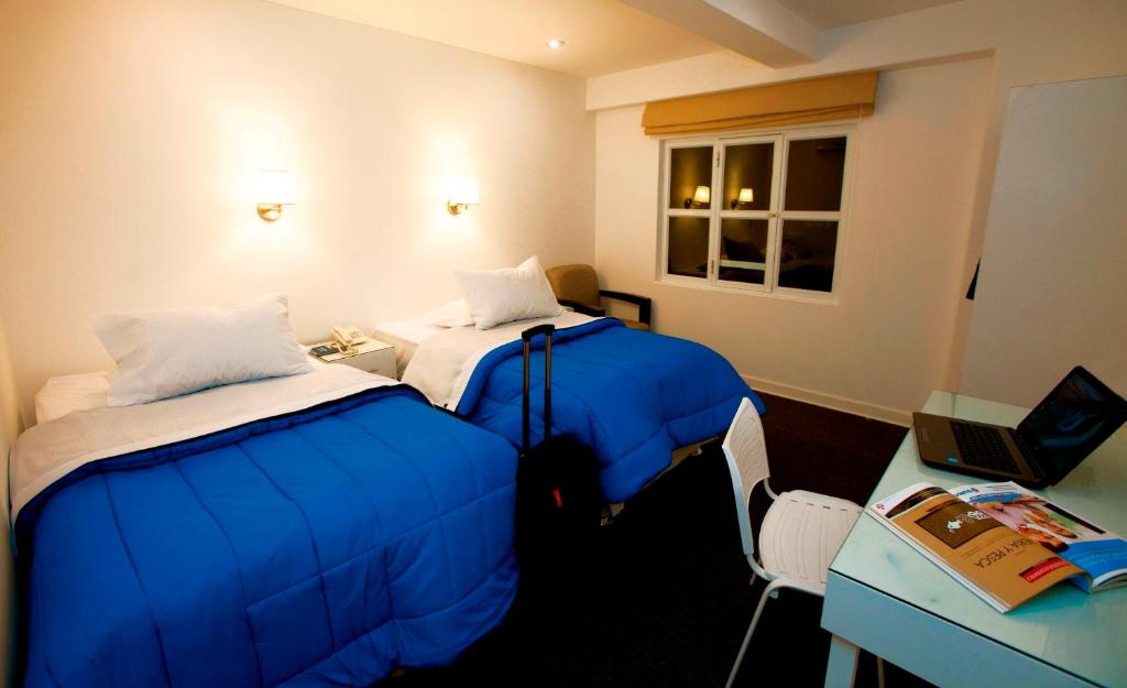 Postel nebo postele na pokoji v ubytování Hotel Gran Palma Talara