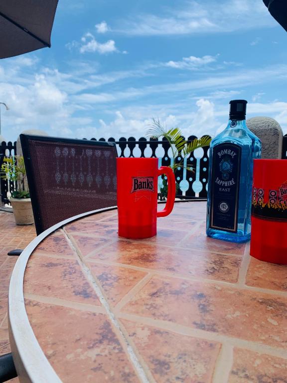 a table with two bottles of alcohol sitting on it at Beach Vue Barbados in Bridgetown