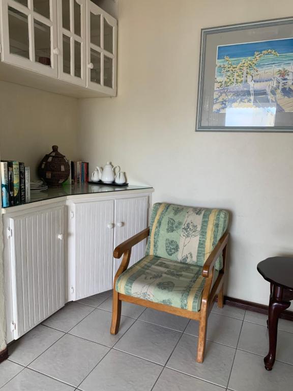 a chair sitting in a room with a counter at Beach Vue Barbados in Bridgetown