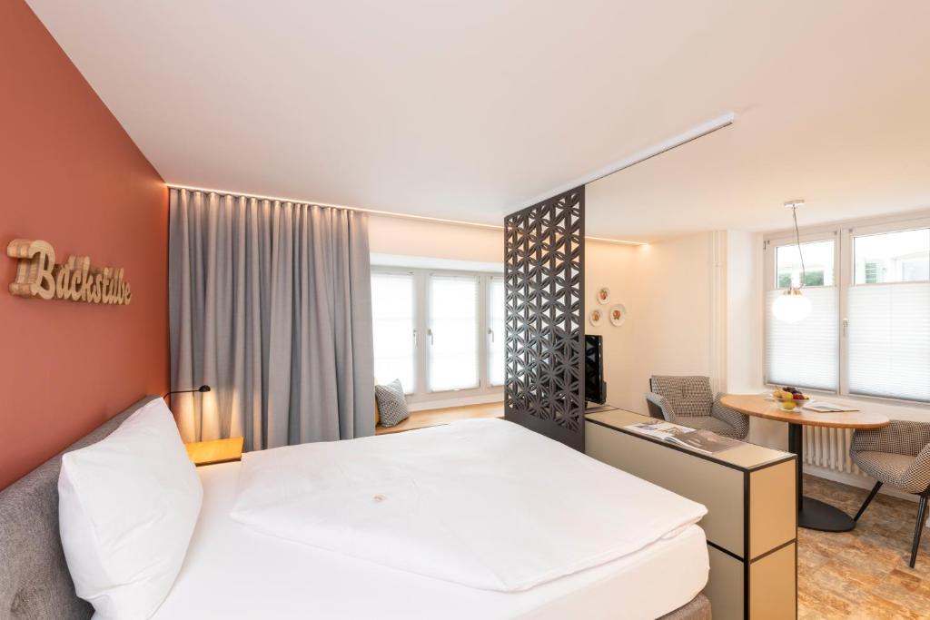 Postel nebo postele na pokoji v ubytování Hotel an der Aare Swiss Quality
