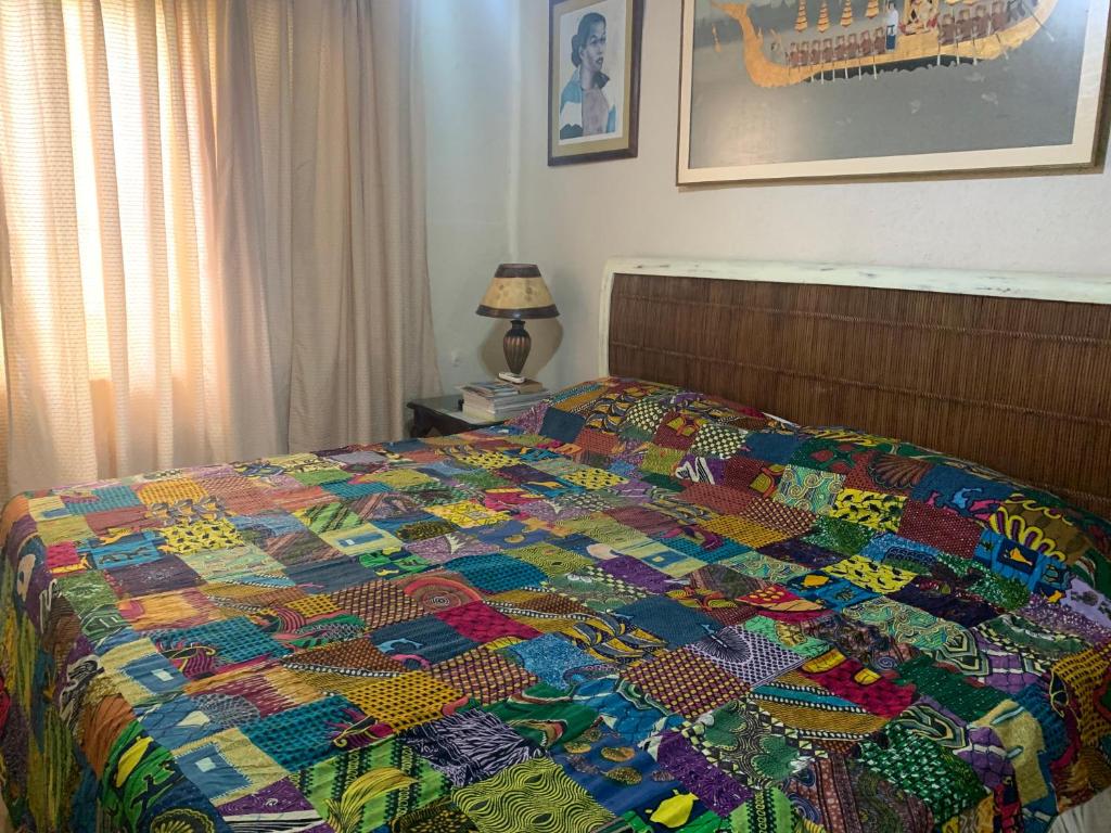 a colorful quilt on a bed in a bedroom at Beach Vue Barbados in Bridgetown