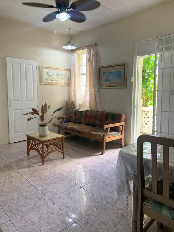 a living room with a couch and a table at Beach Vue Barbados in Bridgetown