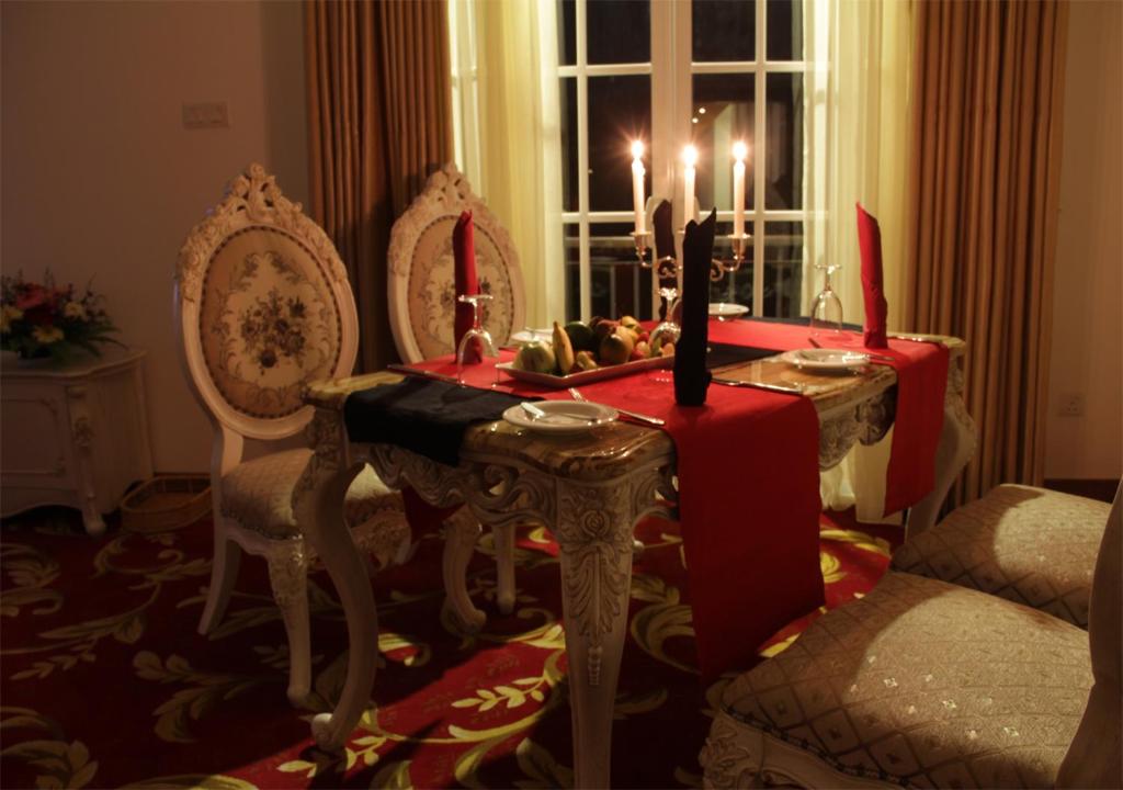 a living room with a table with candles on it at The Blackpool Resort & Spa in Nuwara Eliya