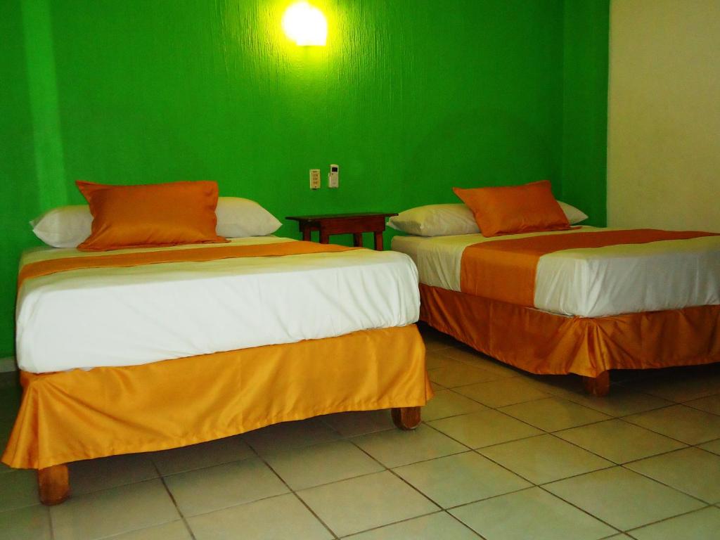 A bed or beds in a room at Casa Mexicana Barra de Navidad