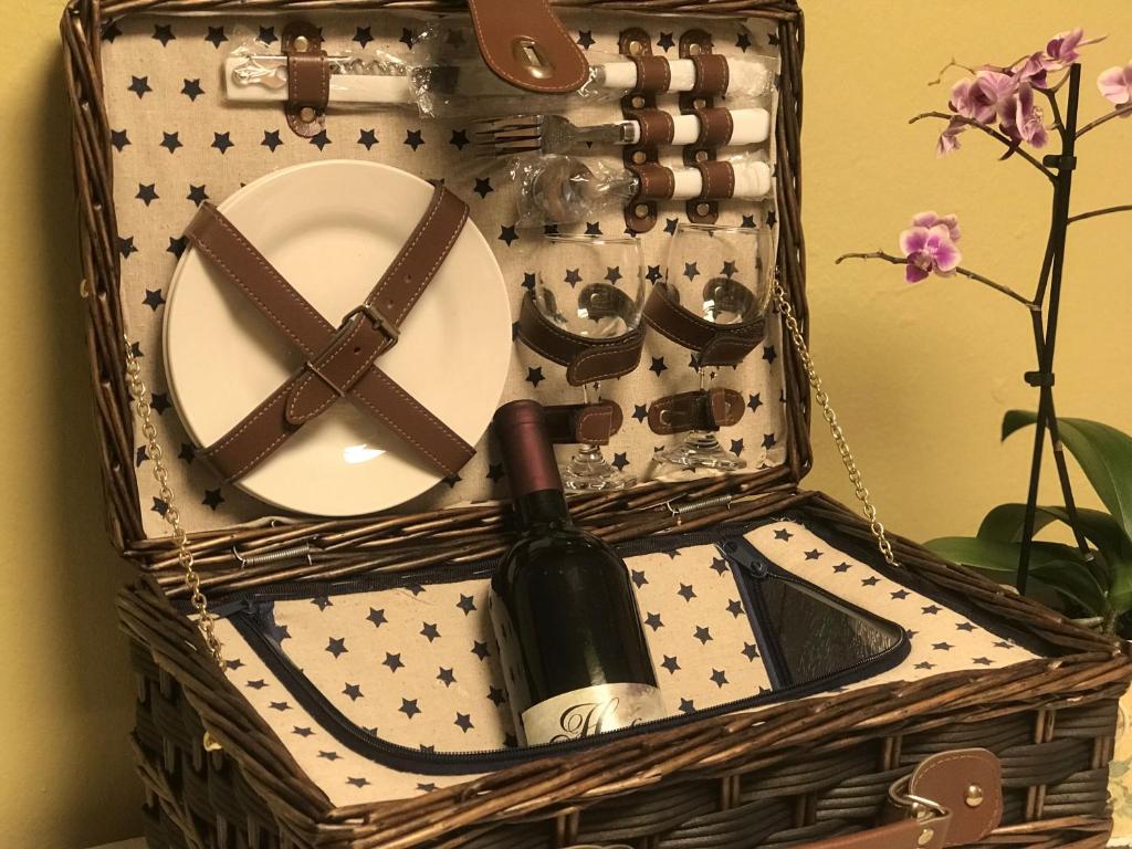a basket with a plate and a bottle of wine at Charming Apartment with Mountain View in Altmünster