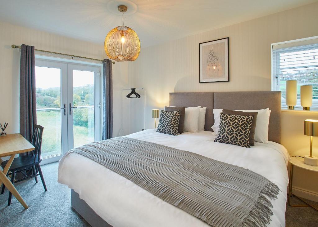 a bedroom with a bed and a desk and a window at Host & Stay - Hoggarths Retreat in Whitby