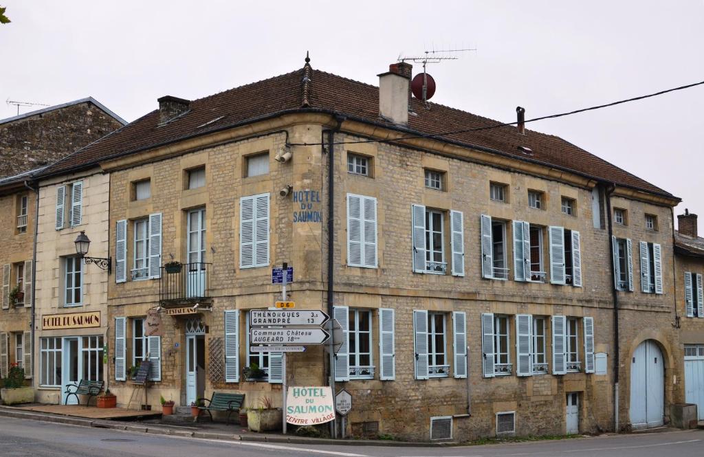 an old brick building on the corner of a street at Hotel du Saumon in Buzancy