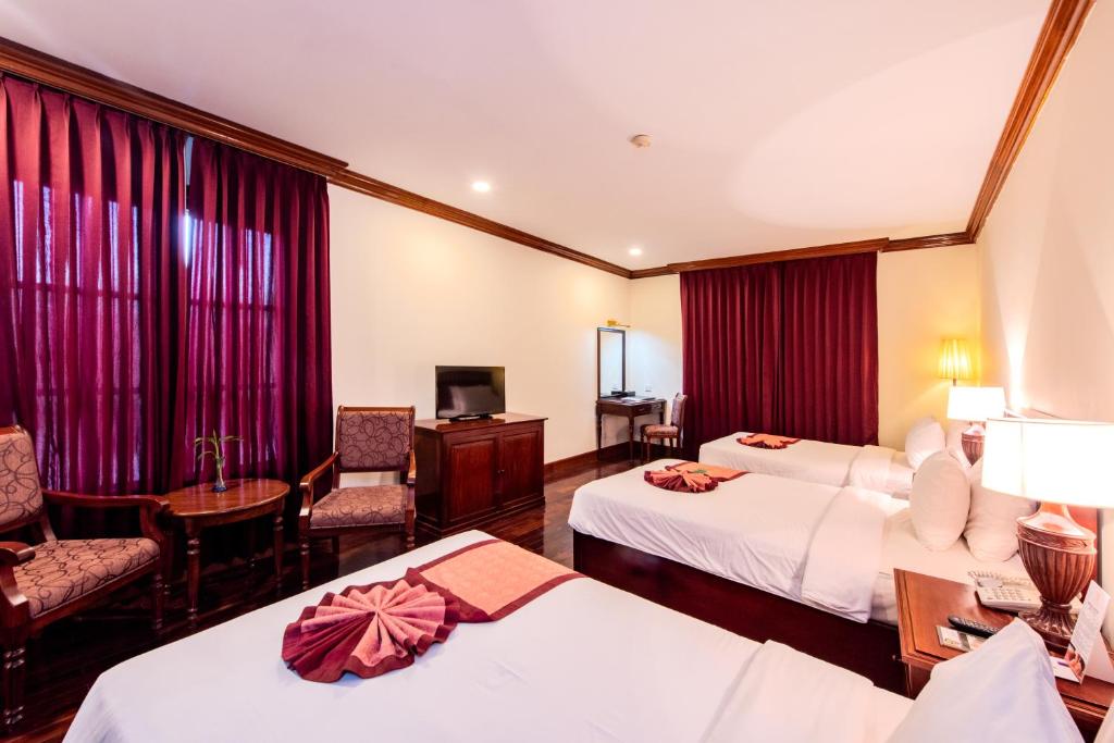Postel nebo postele na pokoji v ubytování Steung Siemreap Hotel
