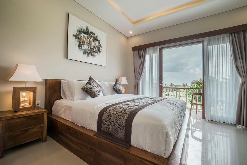 Postel nebo postele na pokoji v ubytování Putih DCarik Ubud