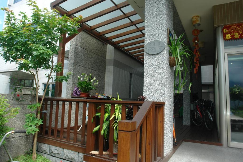 a wooden entrance to a house with a wooden pergola at Hualien Sheraton Hostel in Hualien City