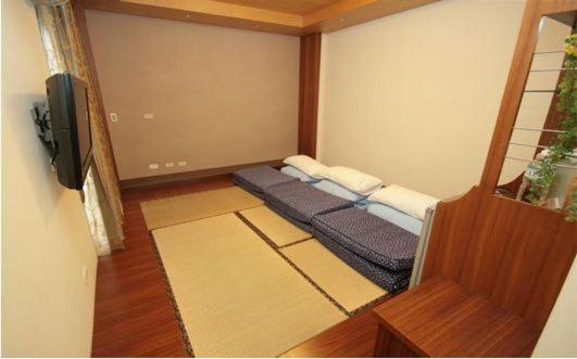 a living room with two beds in a room at Hualien Sheraton Hostel in Hualien City