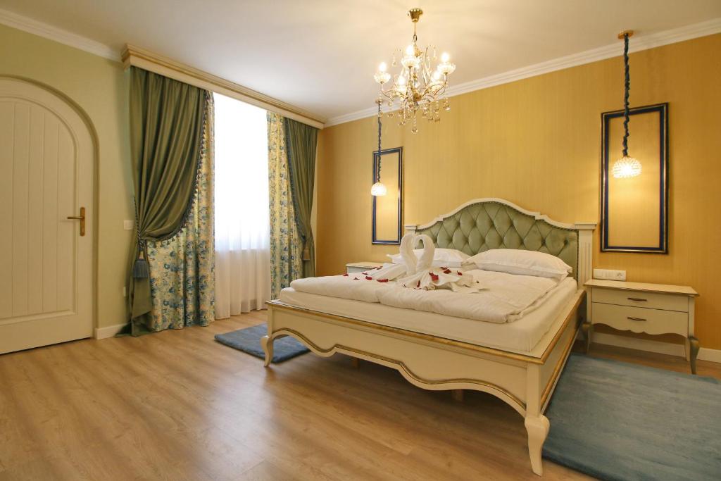 a bedroom with a bed and a chandelier at Casa Kempel in Sibiu