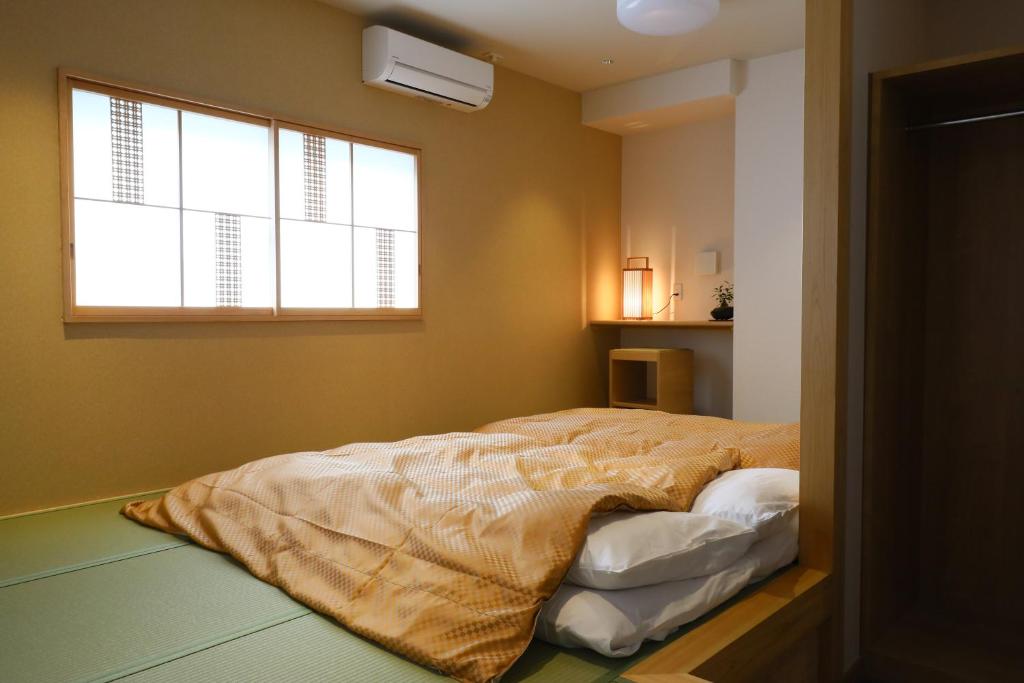Postel nebo postele na pokoji v ubytování Wa Style Tokyo