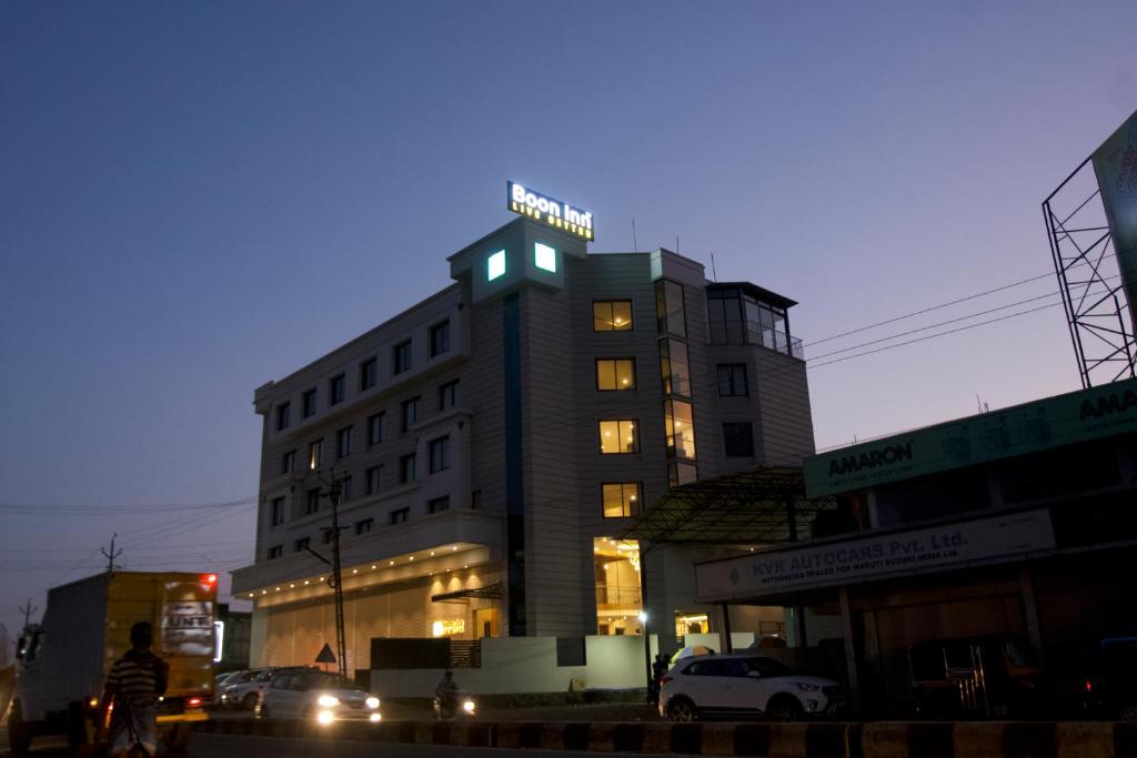 a tall building with lights on top of it at Boon Inn in Malappuram