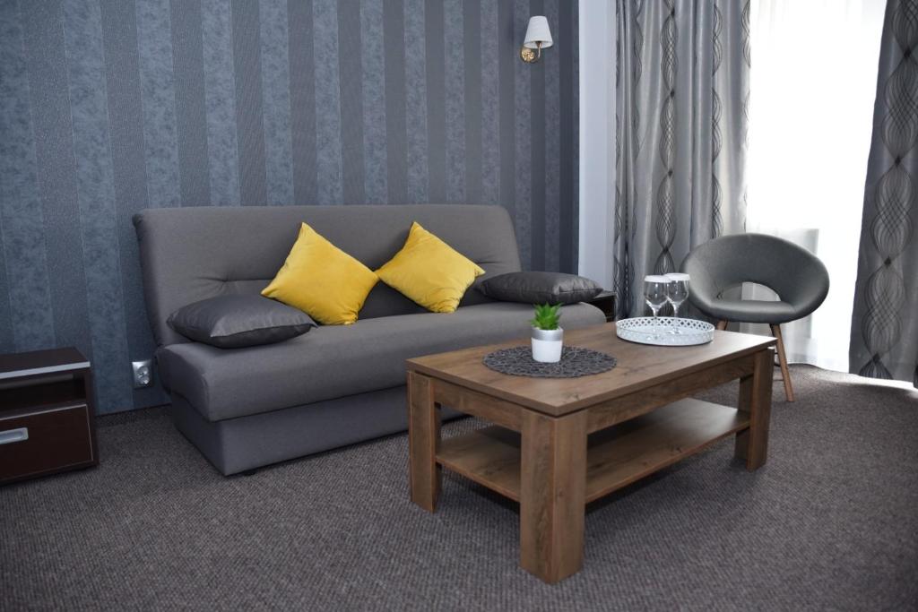 a living room with a couch and a coffee table at Hotel Magurele in Măgurele