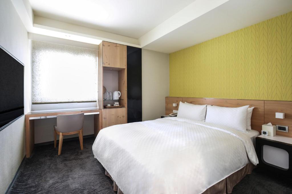 Postel nebo postele na pokoji v ubytování Dandy Hotel-Daan Park Branch
