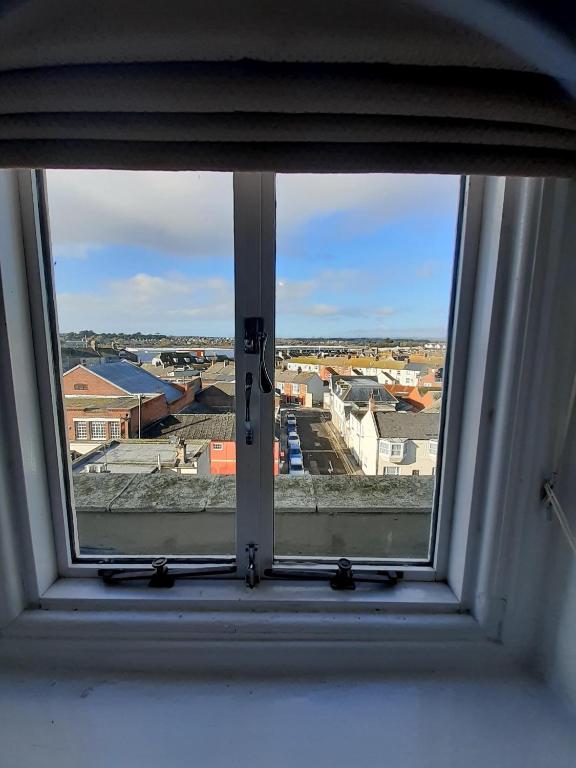an open window with a view of a city at The Edenhurst Guesthouse in Weymouth