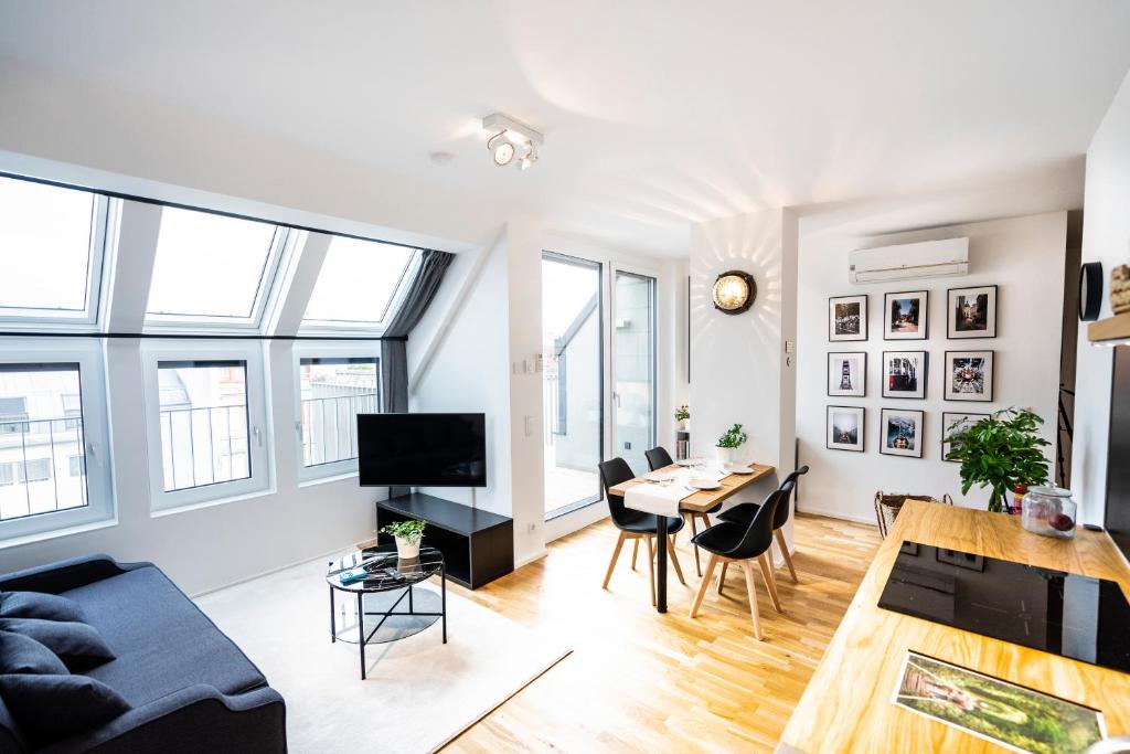 a living room with a couch and a table at Boutique Design-Apartments Vienna in Vienna