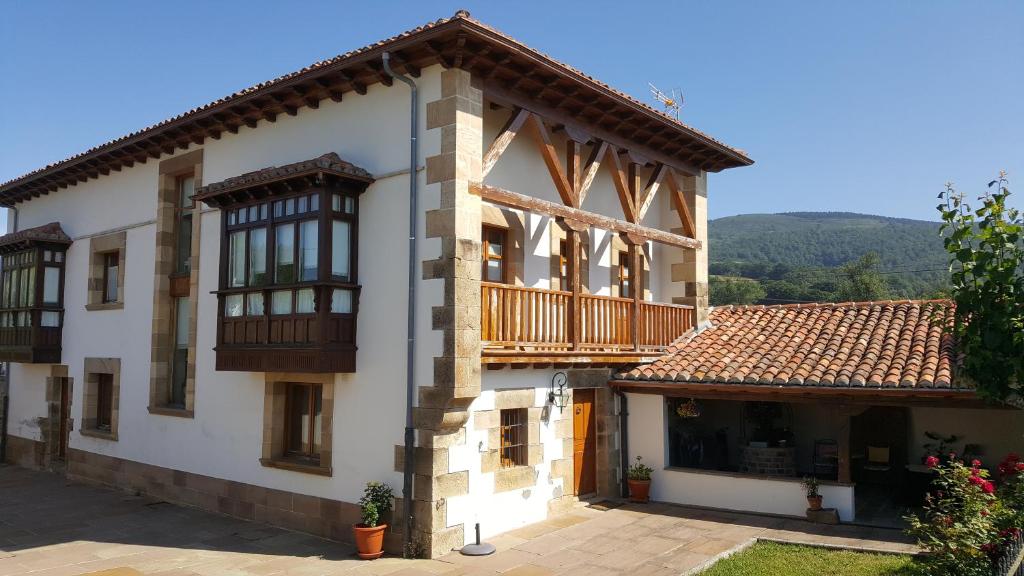 a large white building with a balcony on it at FORJAS DE ORZALES in Orzales