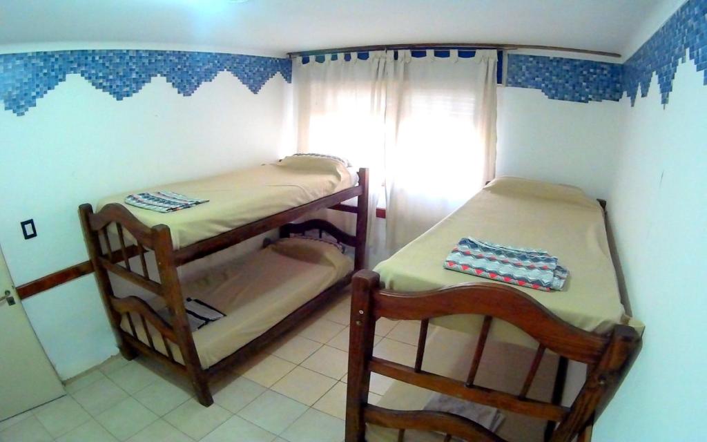 a small room with two bunk beds in it at San Juan Hostel in San Juan