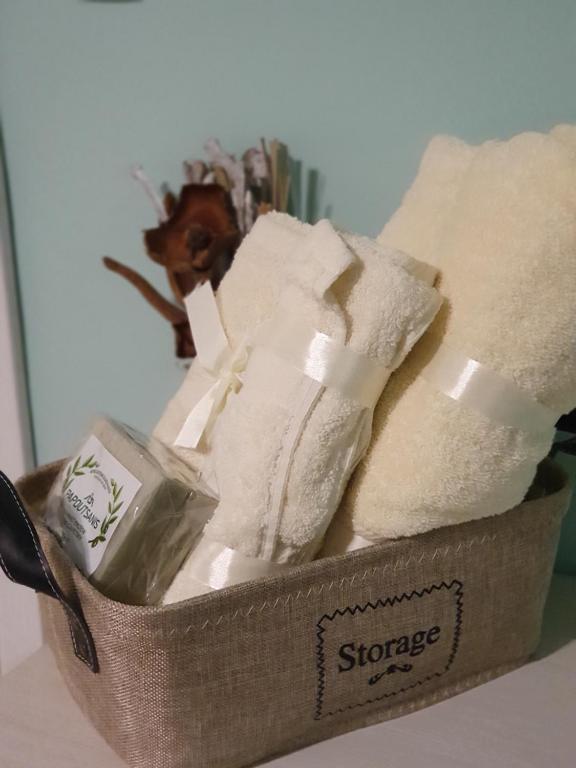 a basket filled with towels and a bottle of soap at Stay Inn Plovdiv in Plovdiv